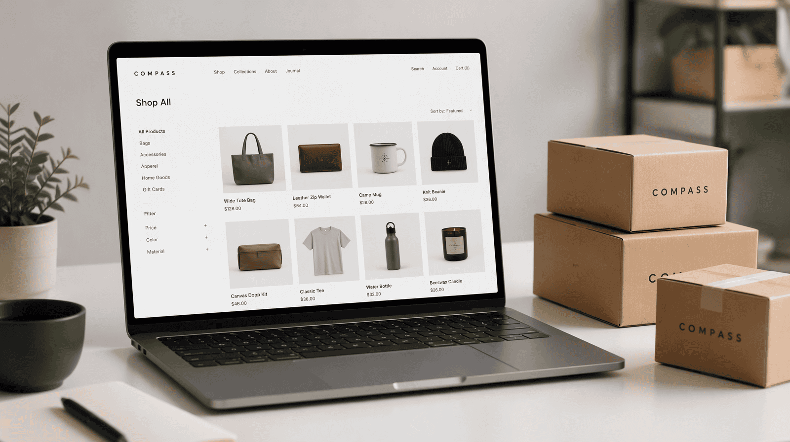 Laptop showing a Shopify online store product page beside shipping boxes